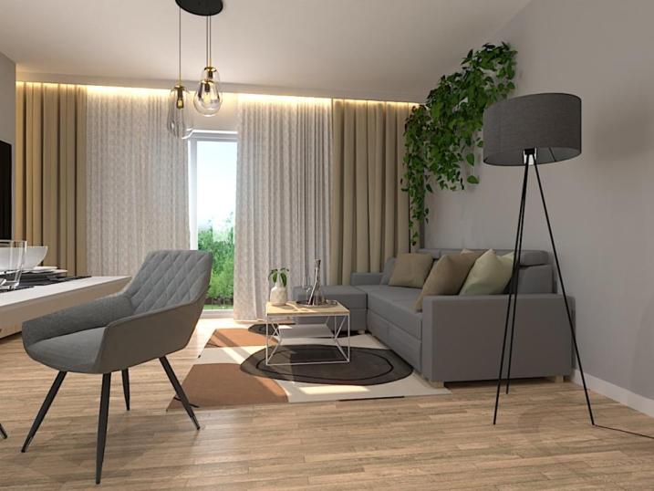 Aranżacja salonu z kuchnią w stylu nowoczesnym w kolorach szary, drewno 