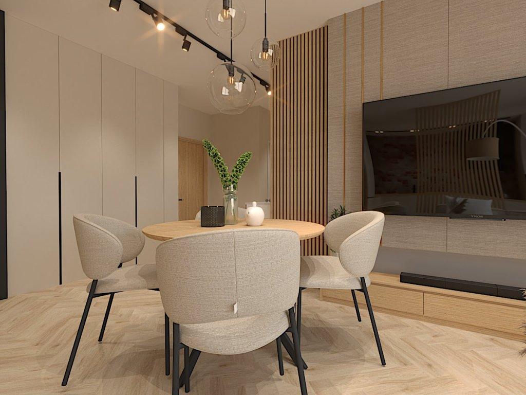 Projekt salonu z aneksem Warszawa na zdjęciu widzimy część jadalnianą ze stołem okrągłym i krzesłami w kolorze beżowym nad stołem szklane lampy