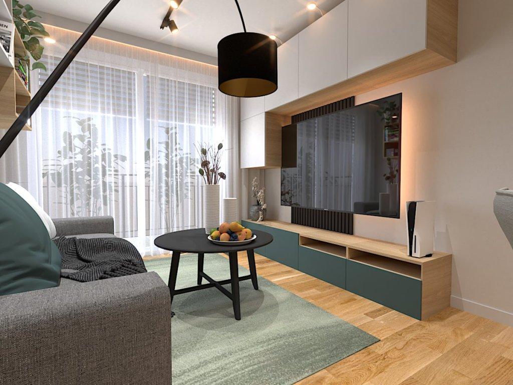 Projekt salonu z kuchnią, jadalnią Wrocław na wizualizacji widzimy strefę wypoczynkową w salonie, czarny stolik kawowy, dużą czarną lampę stojącą , zielony dywan, szafkę rtv i ciemno szarą sofę w oknie są firany , karnisz jest ukryty listwą karniszową z listwą LED